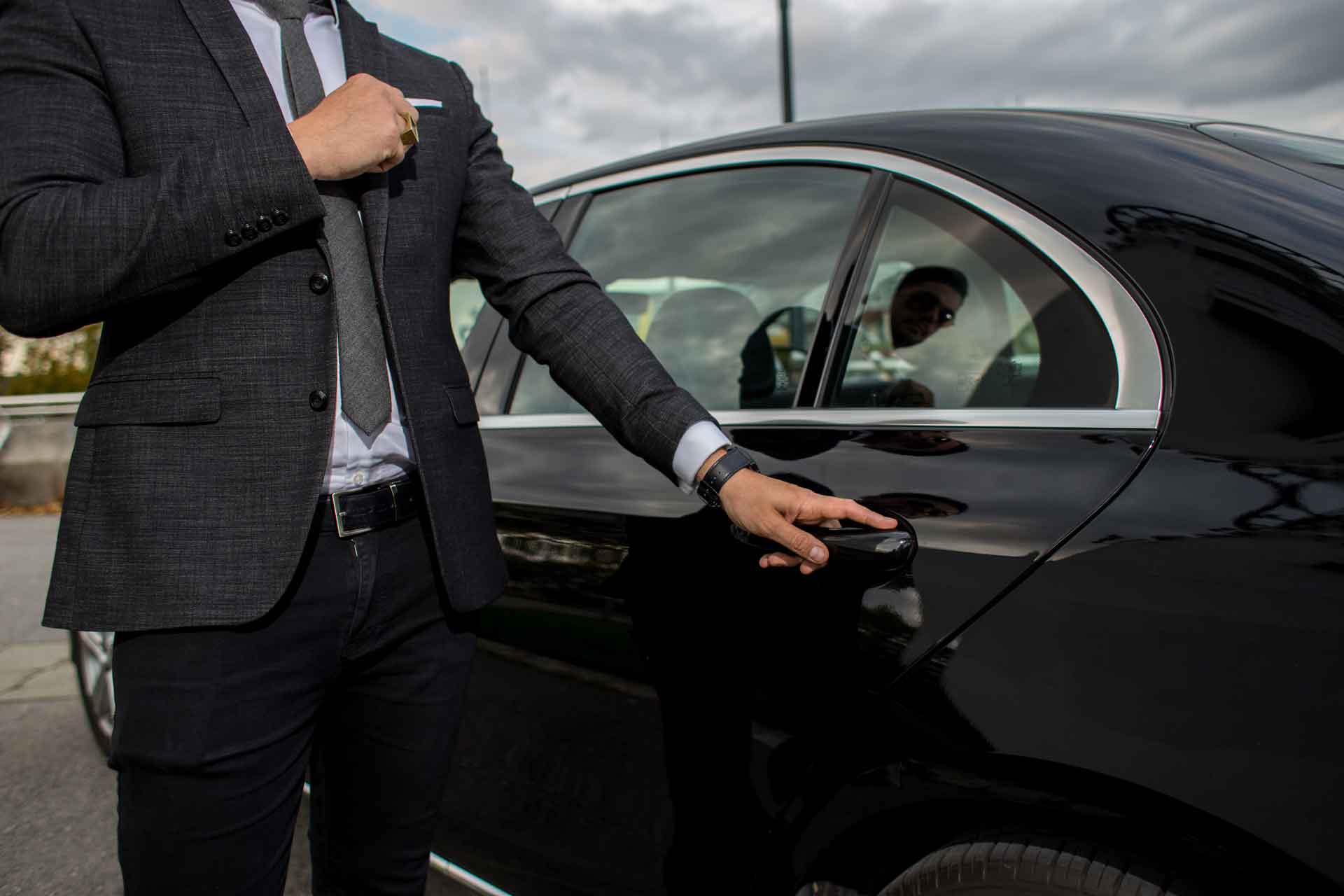 Chauffeur opens car door