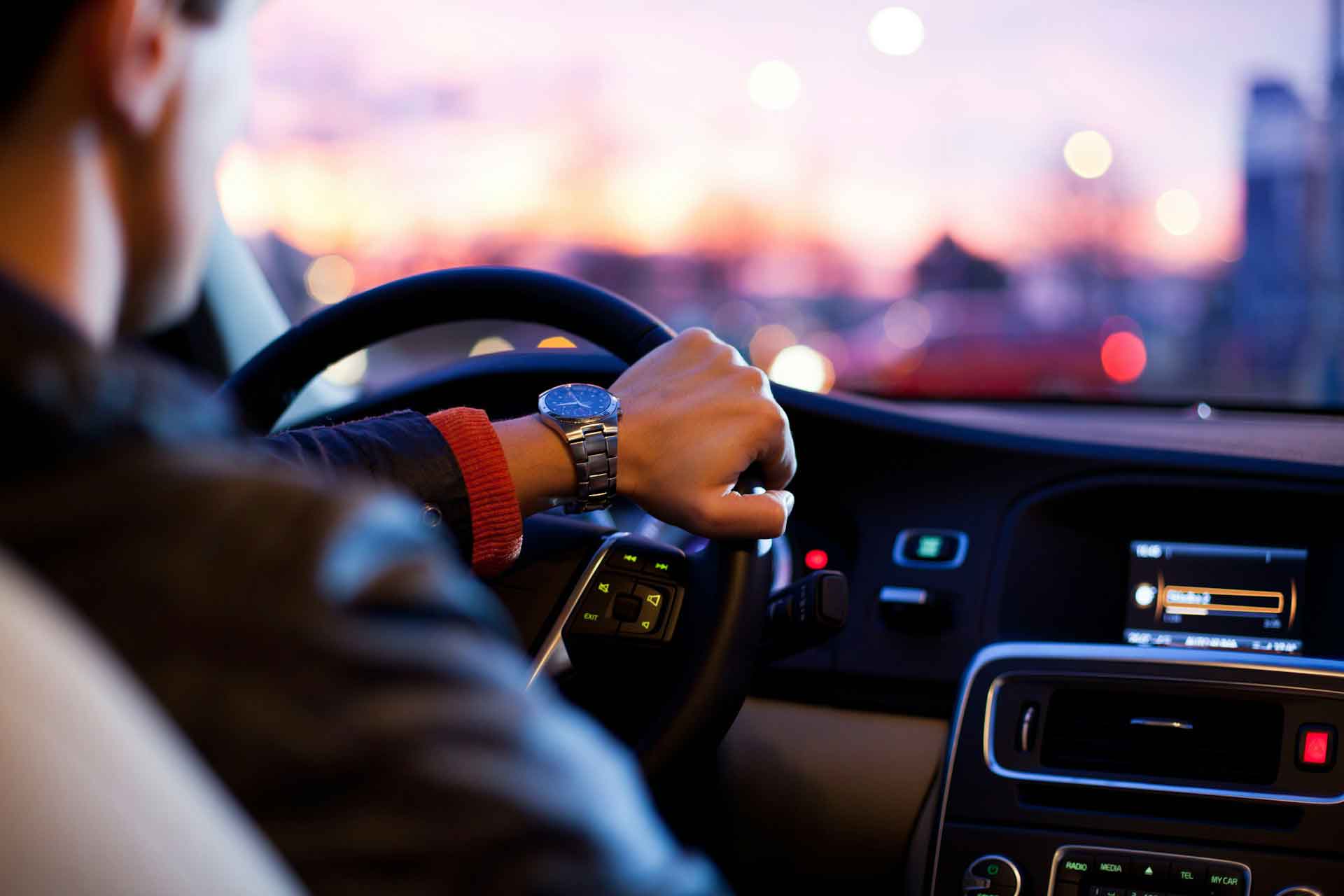 Over-the-shoulder shot of a chauffeur driving a car